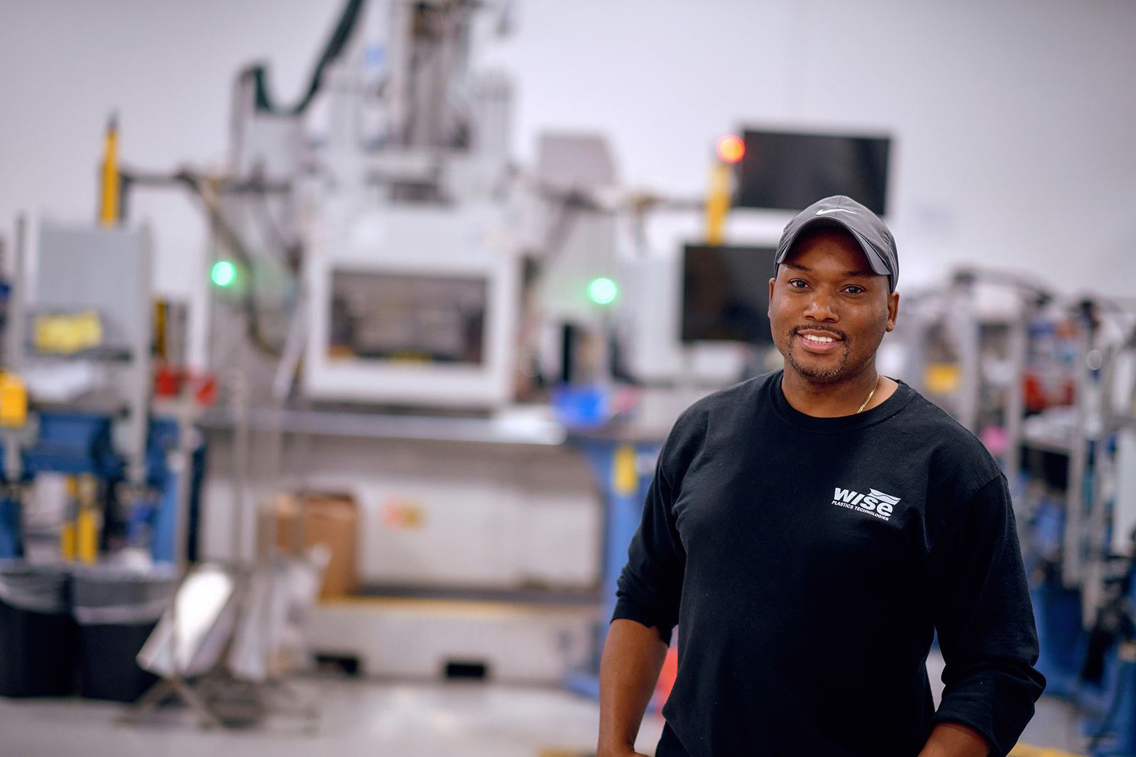 Smiling Wise Plastics technician on the production floor