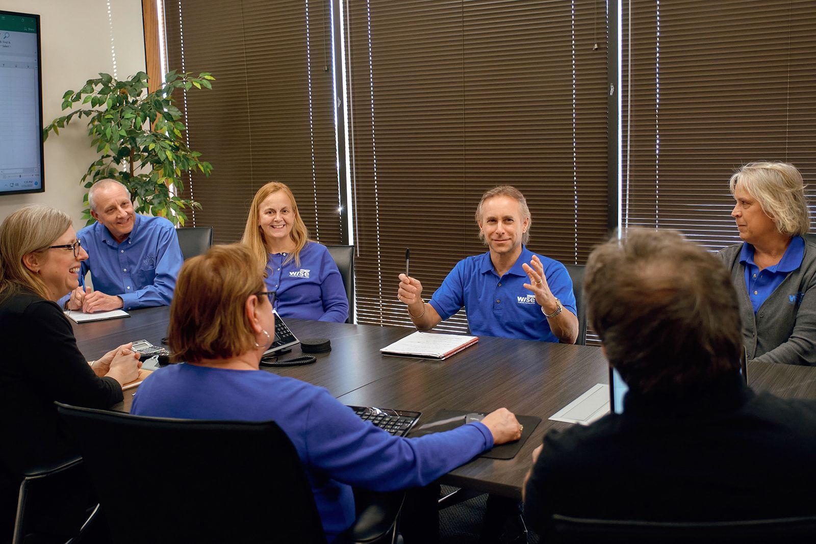 Wise Plastics team members collaborating around the conference table at the St. Charles headquarters